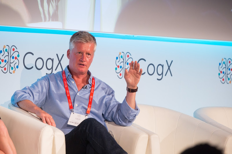 Calum Chace on stage at speaking event CogX.